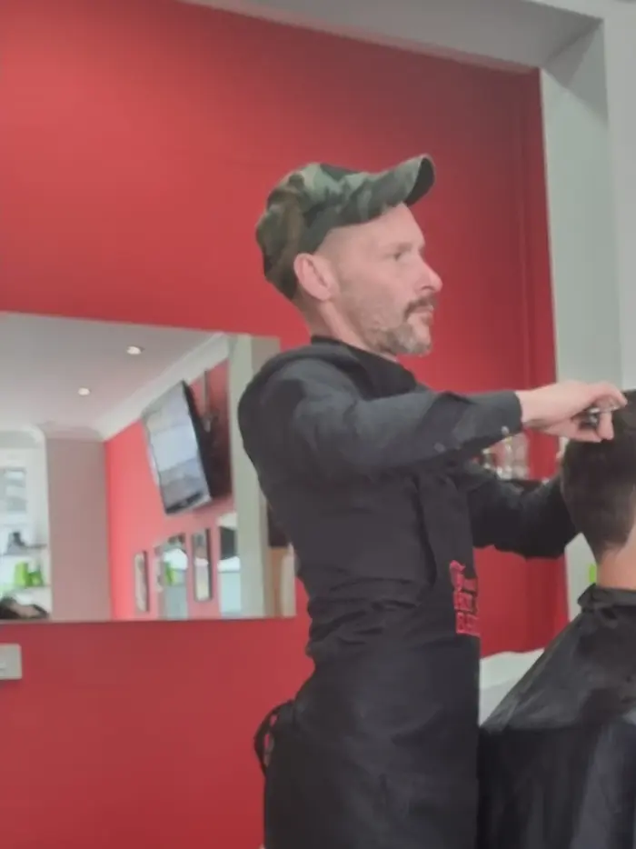 Barber mid-cut, styling a customer's hair at First Class Barbers Hot Shave